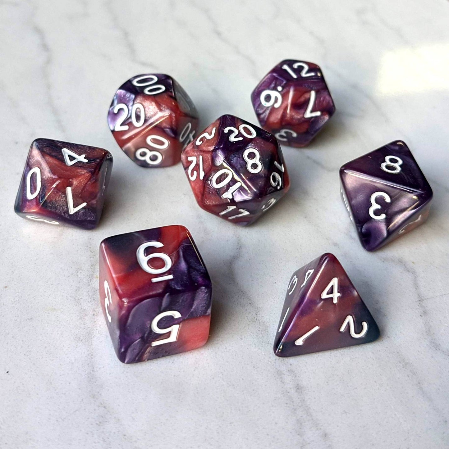 Purple and rose marbled pearly dice set with white numbers for tabletop RPGs like Dungeons and Dragons.