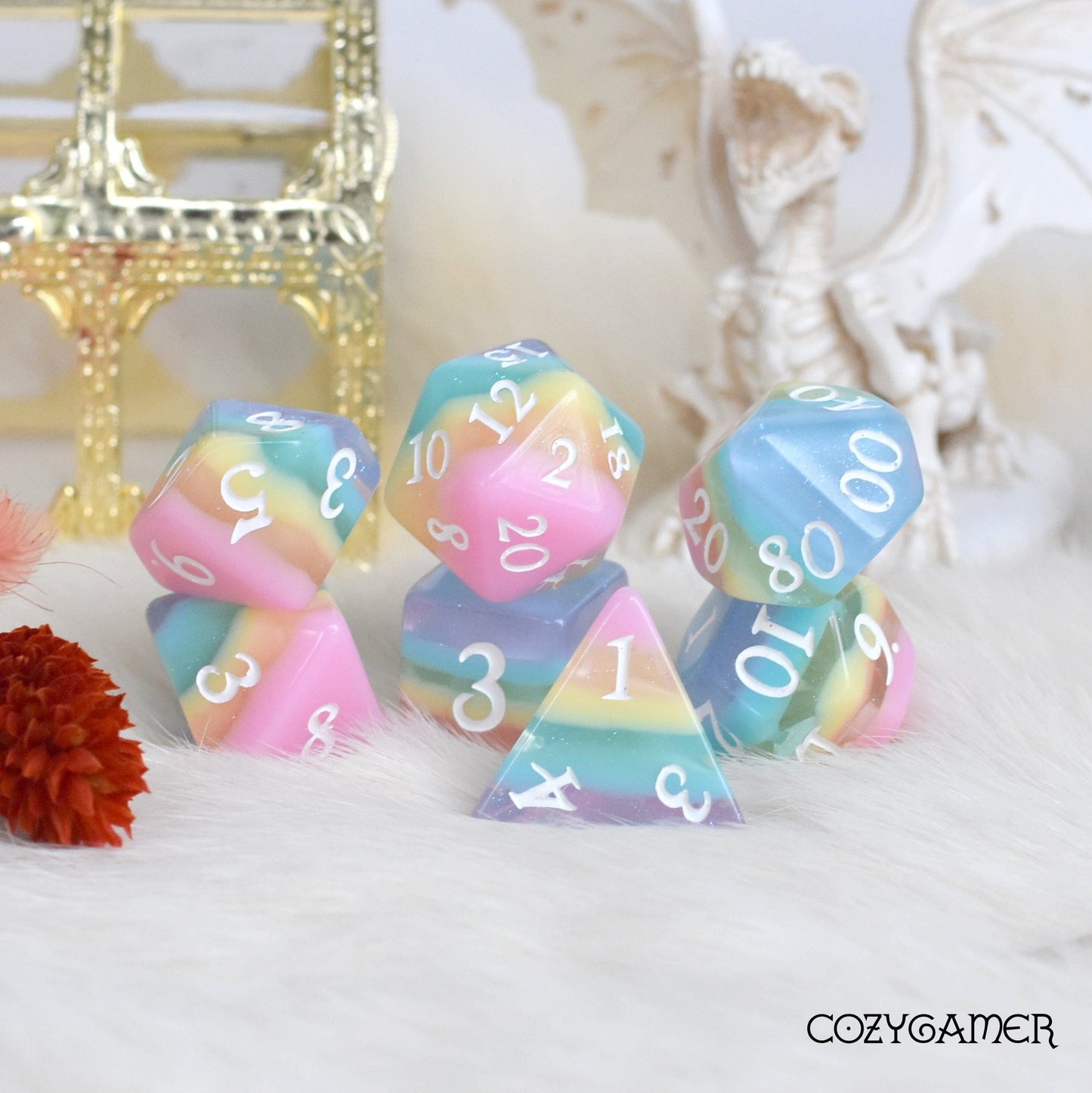 Pastel rainbow stripe DnD dice set with clear glitter layers, featuring polyhedral dice for tabletop gaming.