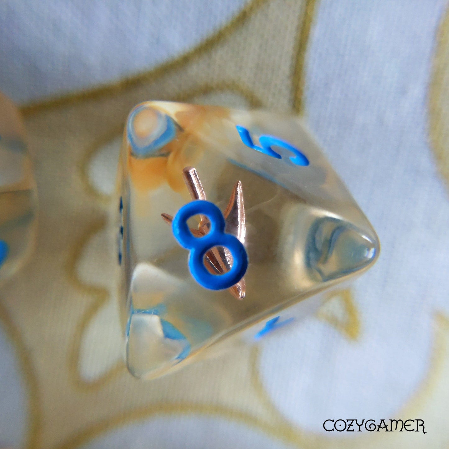 D8 from Ranger's Arrow Dice Set featuring blue numbers and arrowhead design in golden resin for tabletop RPGs.