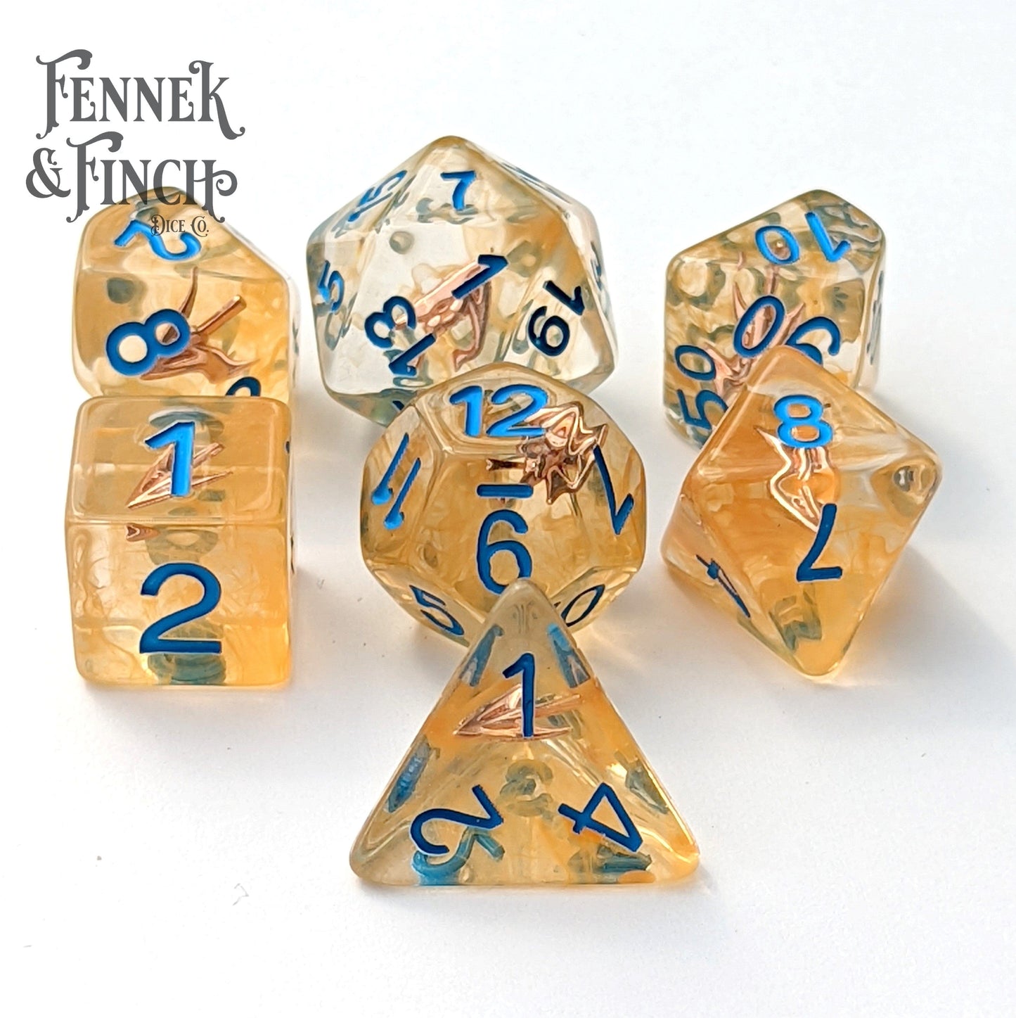 Ranger's Arrow Dice Set with golden resin and blue font, featuring tiny arrowheads for DnD and tabletop RPGs, 7 polyhedral dice.