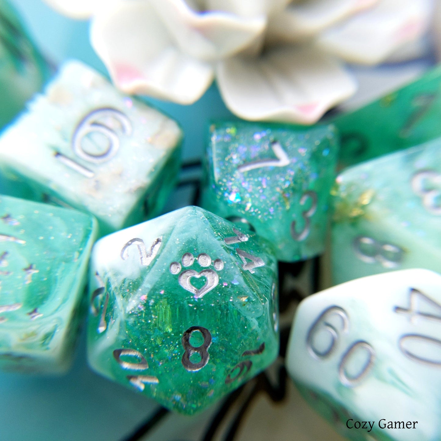 Seafoam 8 Piece Dice Set in clear teal with glitter and foil, featuring custom paw and star designs by CozyGamer.
