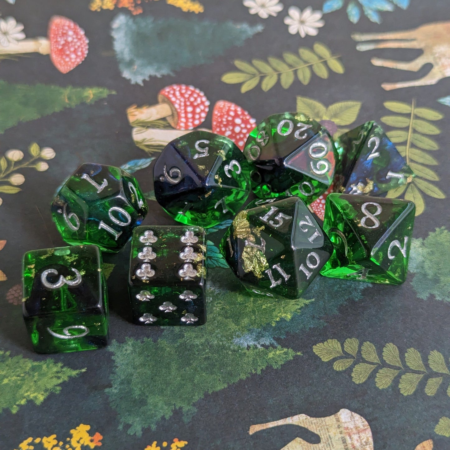 Shadowy Forest DND 8 piece green resin dice set with silver numbers on nature-themed background.