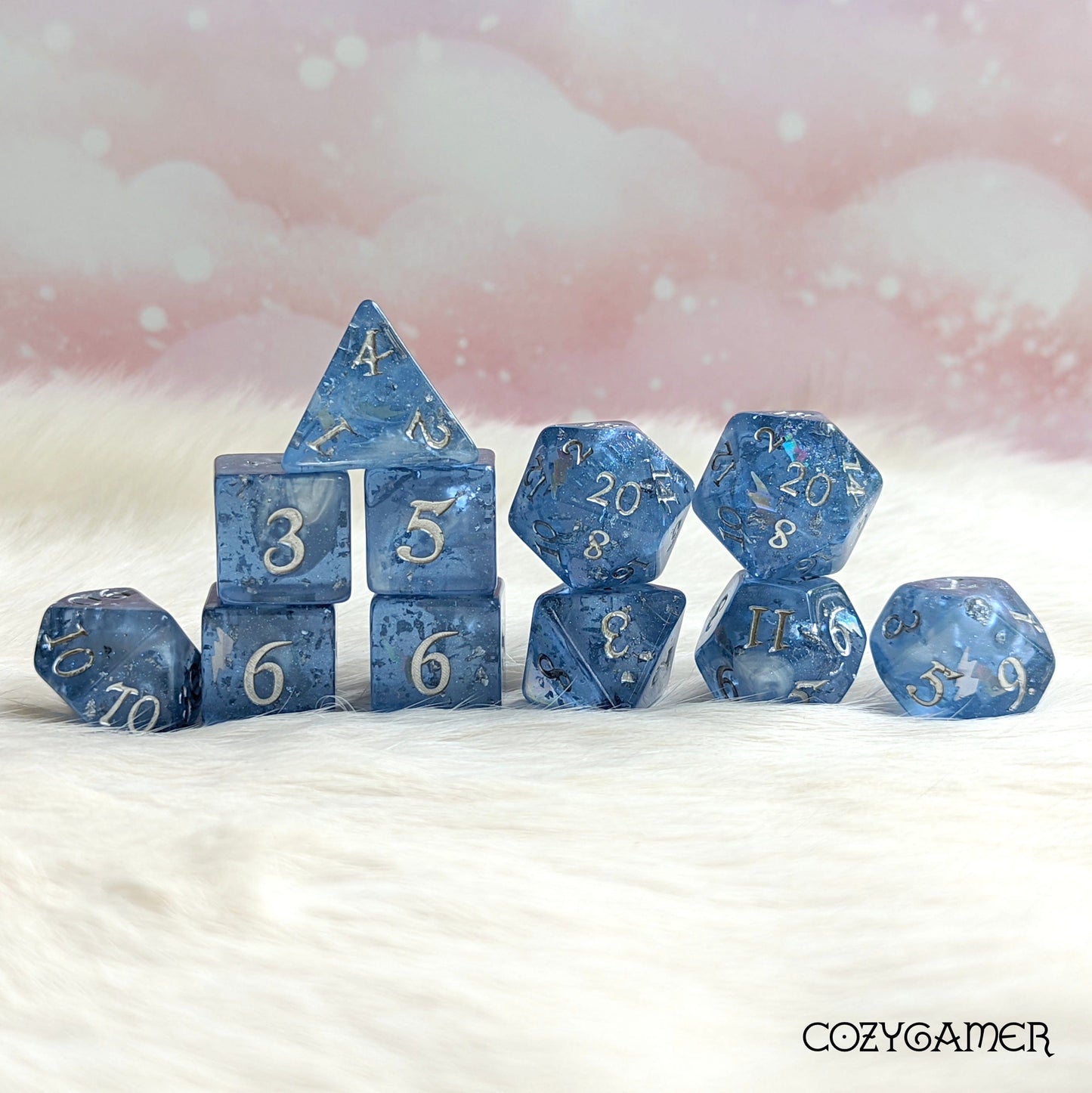 Storm Daddy DnD dice set with blue hues, shimmering clouds, glitter, and silver numbers on a soft background. Perfect for role-playing games.