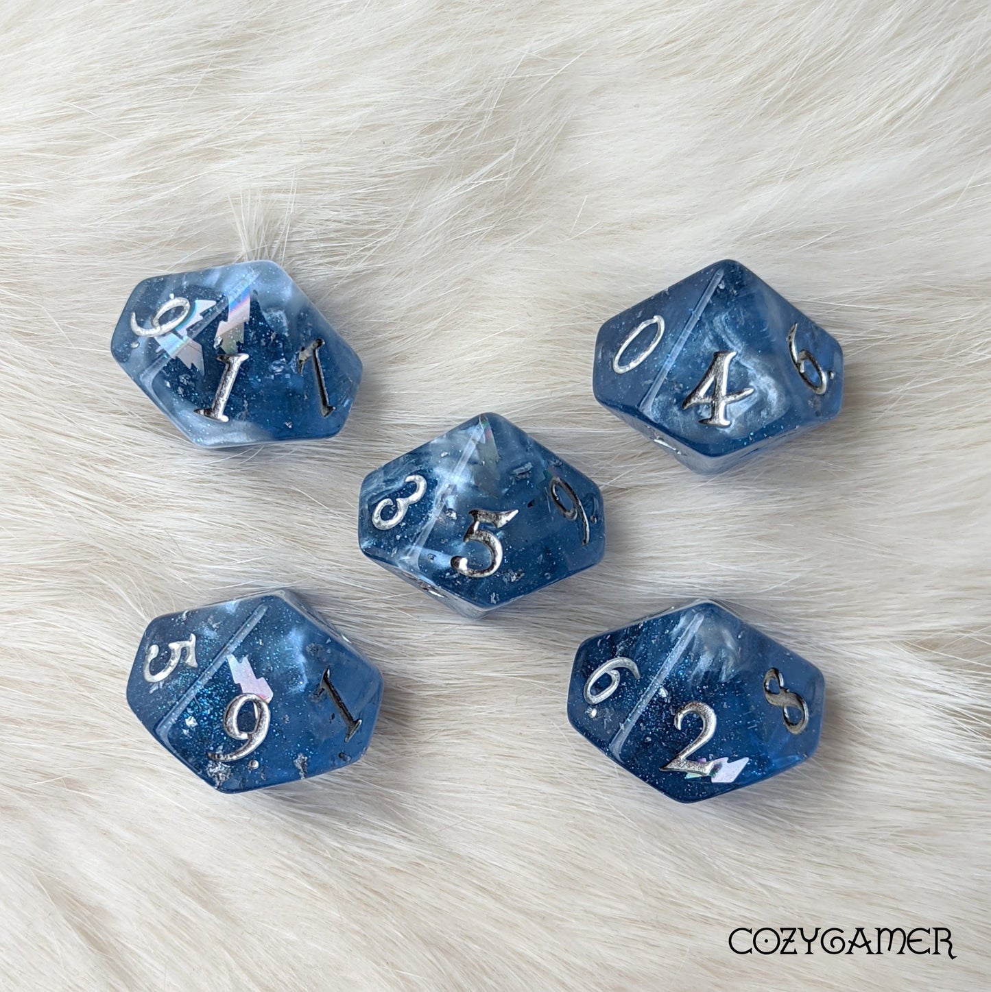 Storm Daddy DnD dice set with deep blue, glittery design and metallic numbers on a soft background. Perfect for Tempest Cleric.