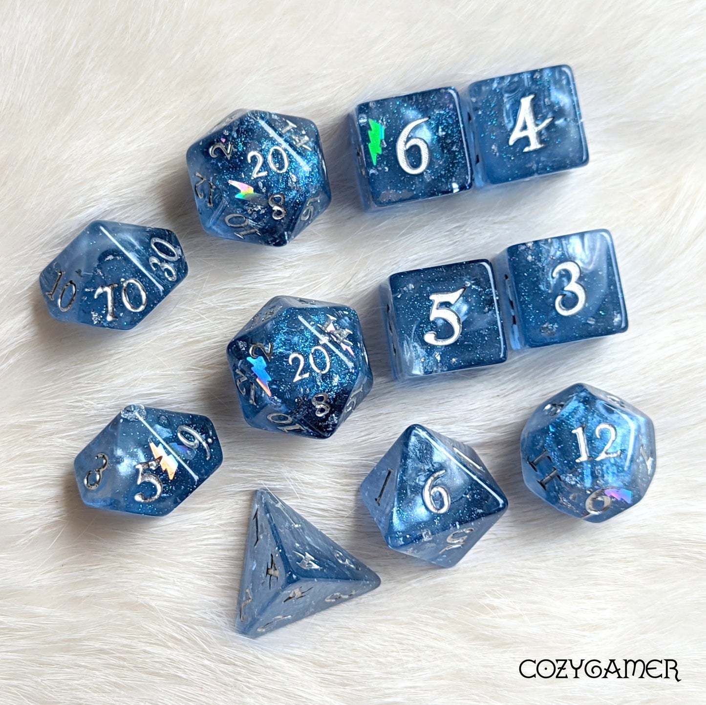 Deep blue Storm Daddy DnD dice set with shimmering clouds and holographic lightning, including D20, D12, D10, and more on white fur background.