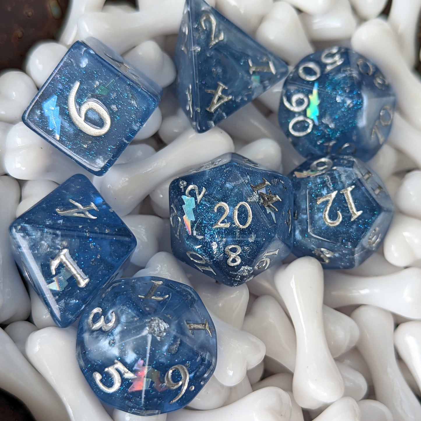 Storm Daddy DnD dice set, deep blue with white clouds, blue glitter, holographic lightning, silver font, perfect for Dungeons & Dragons.