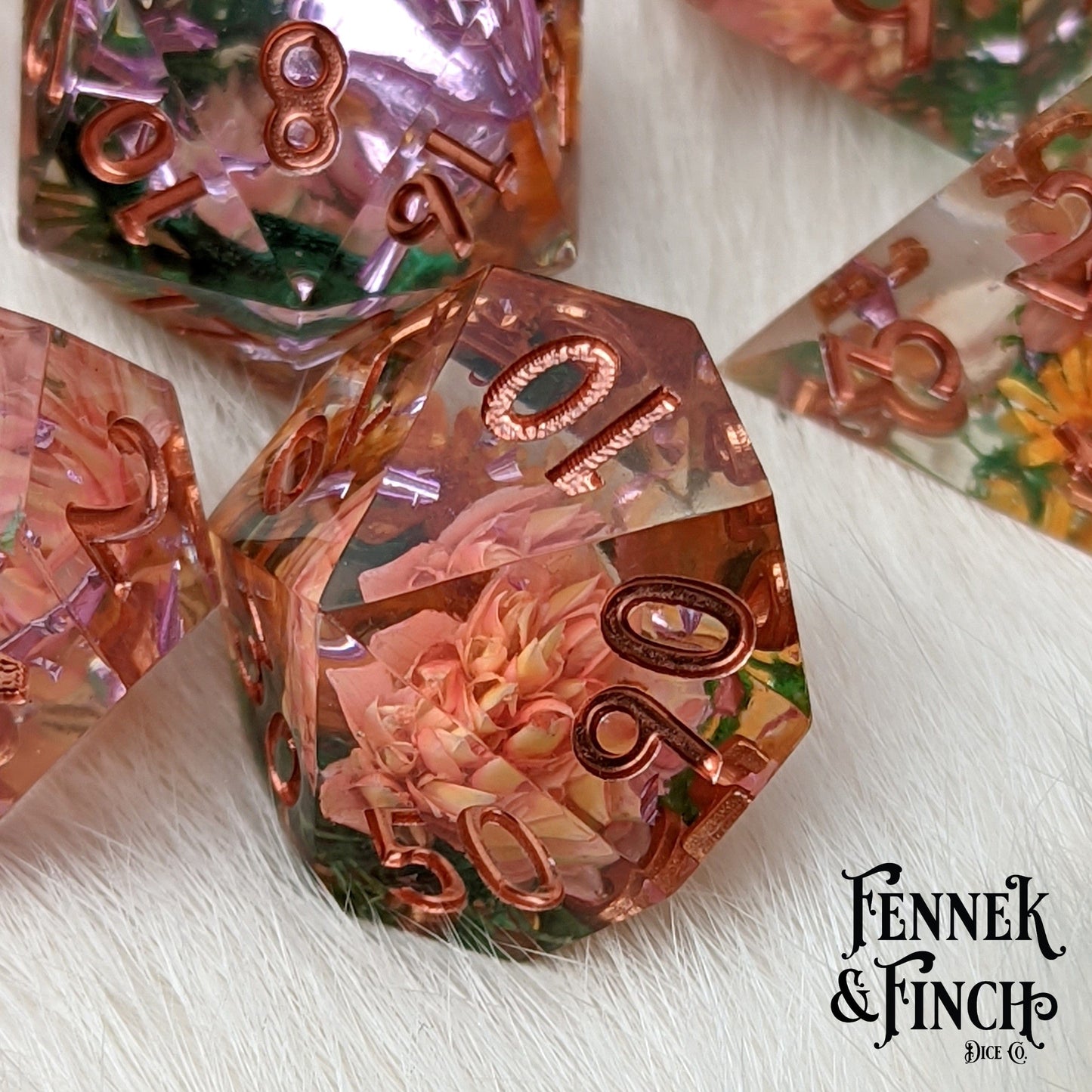 Sunny Garden DnD dice set with dried orange and pink flowers inside, featuring sharp edges and hand-finished design.