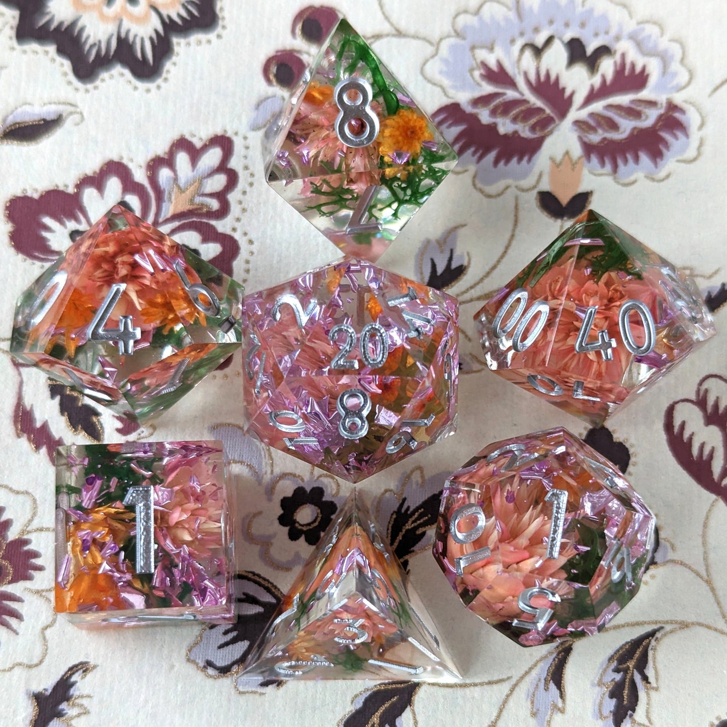 Sunny Garden DnD dice set with dried orange and pink flowers inside on floral background, perfect for druids or herbalists.