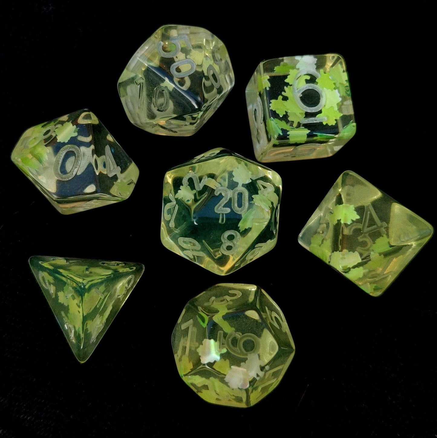 Un-inked Feywild Dice Set in clear resin with light green leaves, 7 polyhedral dice for D&D and TTRPGs, CozyGamer exclusive.