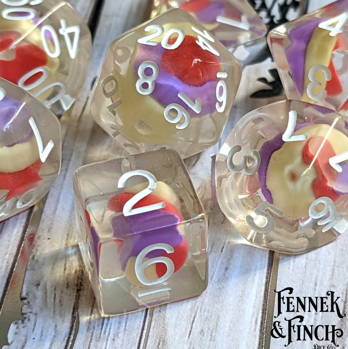 Unicorn Candy Swirl Dice Set with clay candy in clear resin, 7 polyhedral pieces for DnD and TTRPG gaming accessories.