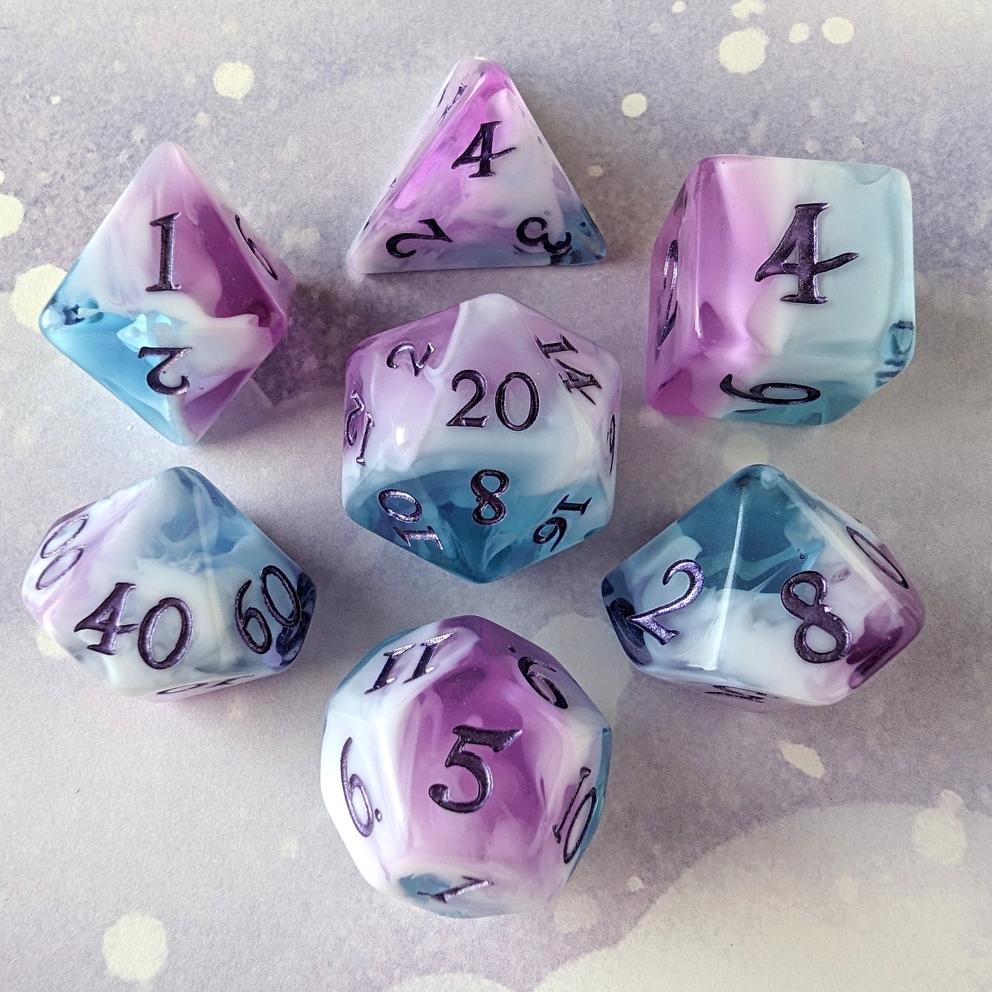 Vale of Dreams marbled DnD dice set with blue, purple, and white colors, featuring metallic deep purple numbers.