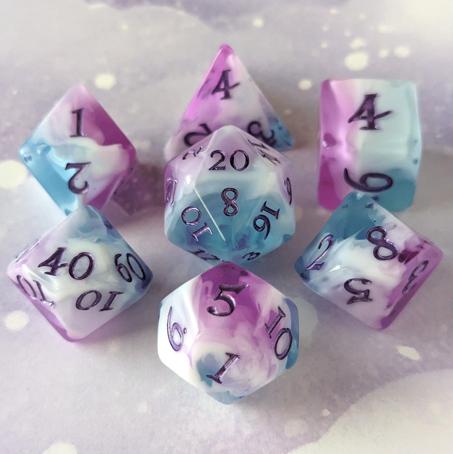 Vale of Dreams DnD dice set with marbled blue, purple, and white colors featuring deep purple numbers, perfect for tabletop gaming.
