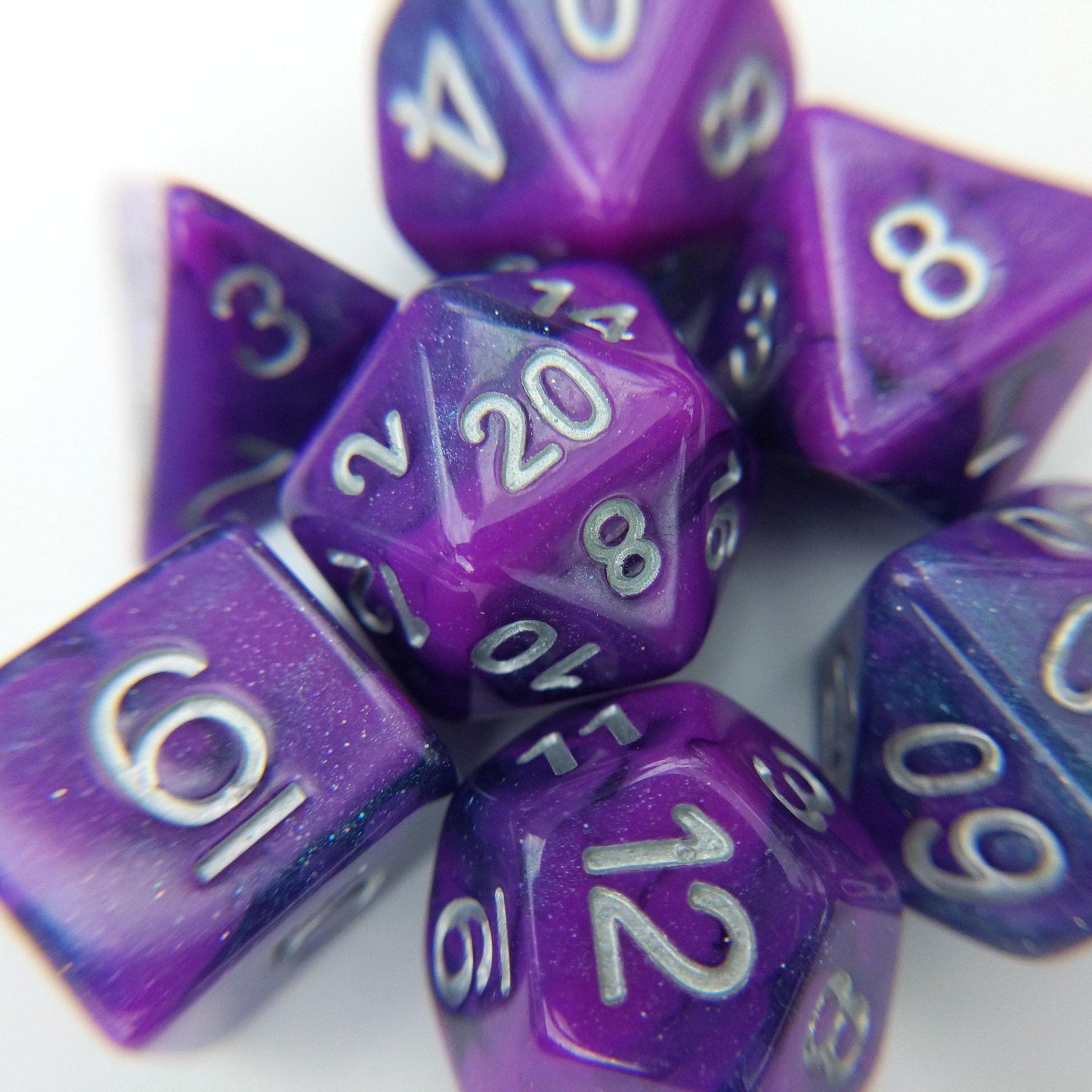 Warlock Flames Dice Set with marbled shimmering purple and blue design and silver font for tabletop RPGs.