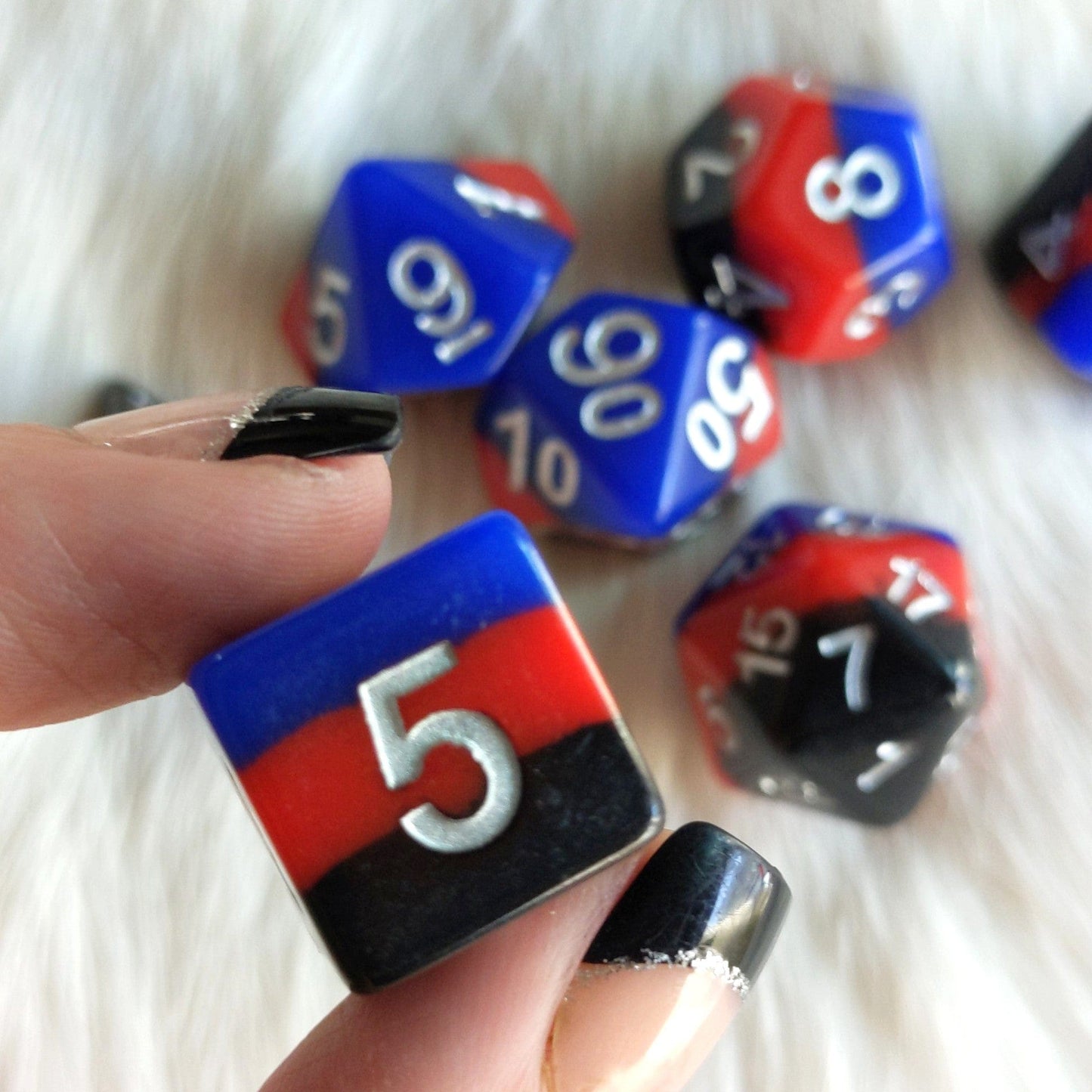 Windsor Castle Dice Set with red, blue, black layers and silver numbers for tabletop RPGs, including Dungeons and Dragons, displayed.