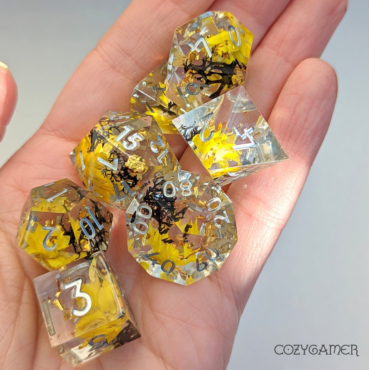 Yellow Flowers and Black Moss Sharp Edge Resin Dice Set. 7 Piece DND dice set with real dried flowers.