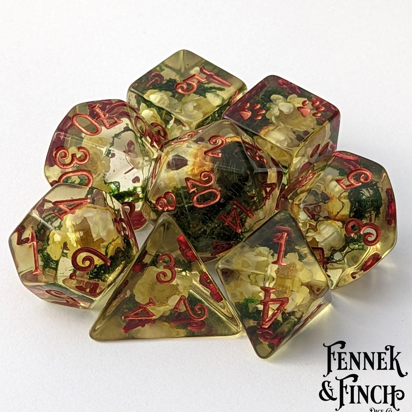 Yellow flowers and moss DnD dice set with dried flowers inside clear tinted yellow resin, perfect for flower lovers and druids.