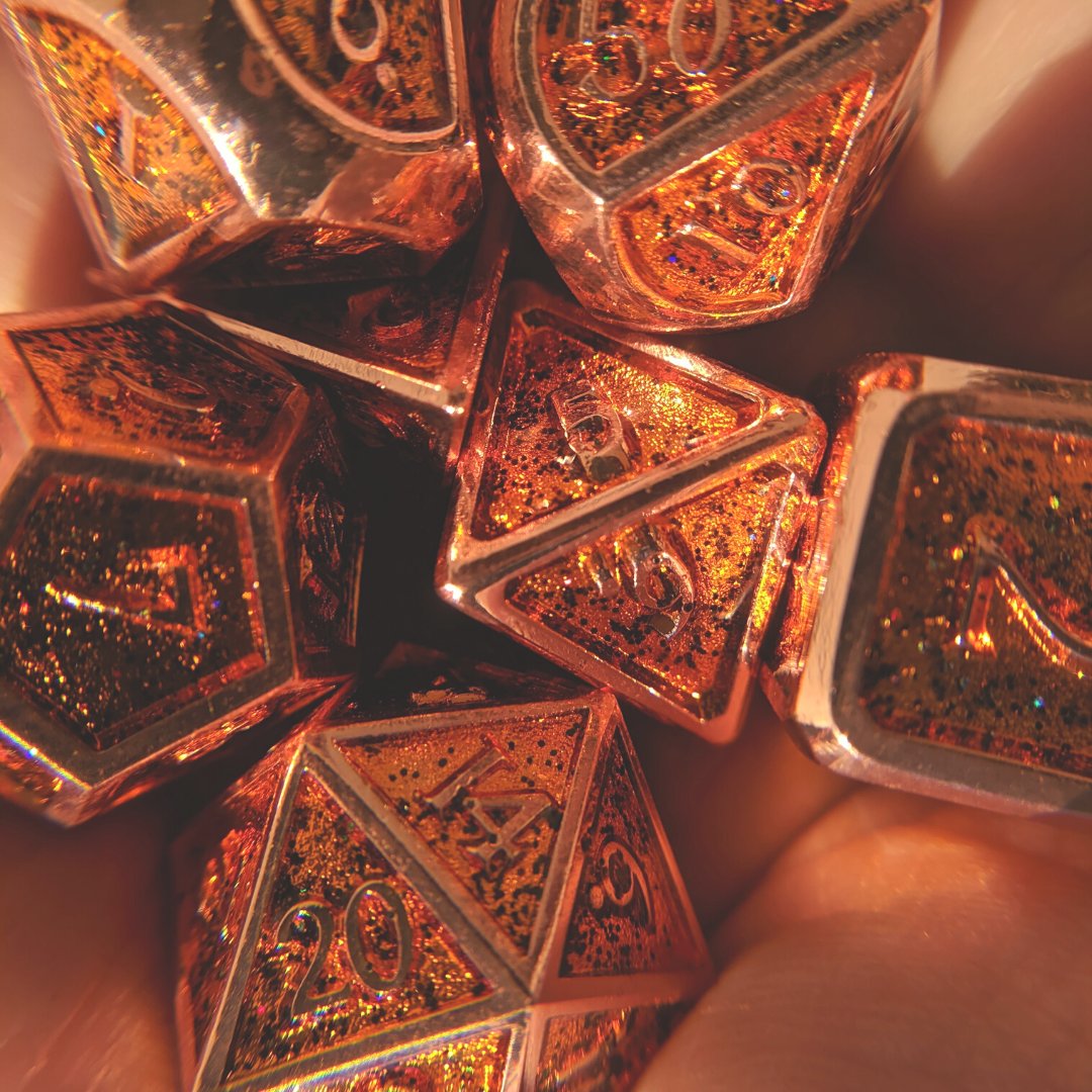 Shiny copper metal dice set with glitter details for tabletop gaming experience