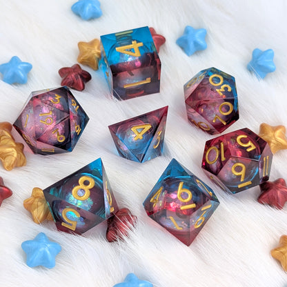 A set of translucent polyhedral gaming dice with a galaxy print, arranged on a white faux fur surface with decorative blue and gold star-shaped props.