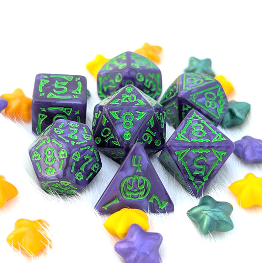 Moonlit Mischief purple Halloween acrylic DnD dice with pearly marbling, bright green numbers, and illustrations of ghosts, bats, broomsticks, skulls, bones, and jack-o'-lanterns