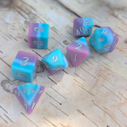 Twilight Serenity Dice Set in teal, blue, and purple hues on wooden surface, perfect for tabletop role-playing games.