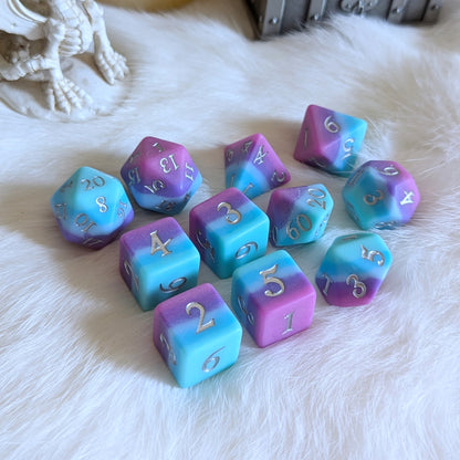 Twilight Serenity Dice Set with ombre hues from teal to purple, featuring a matte finish for TTRPG gameplay on a white surface.