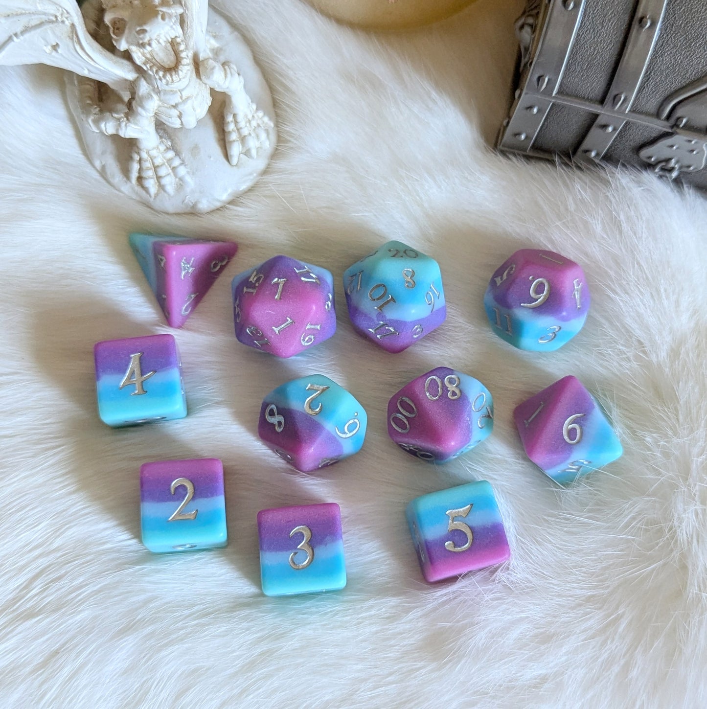 Twilight Serenity Dice Set with ombre hues, teal to pink, featuring a matte finish on a soft fur background for TTRPG gameplay.