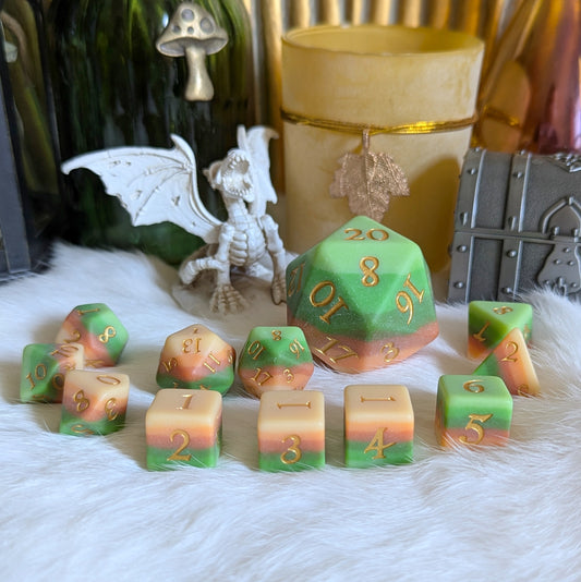 Forest's Heart dice set featuring layered ombre resin in green, brown, and yellow tones with metallic gold fantasy font.