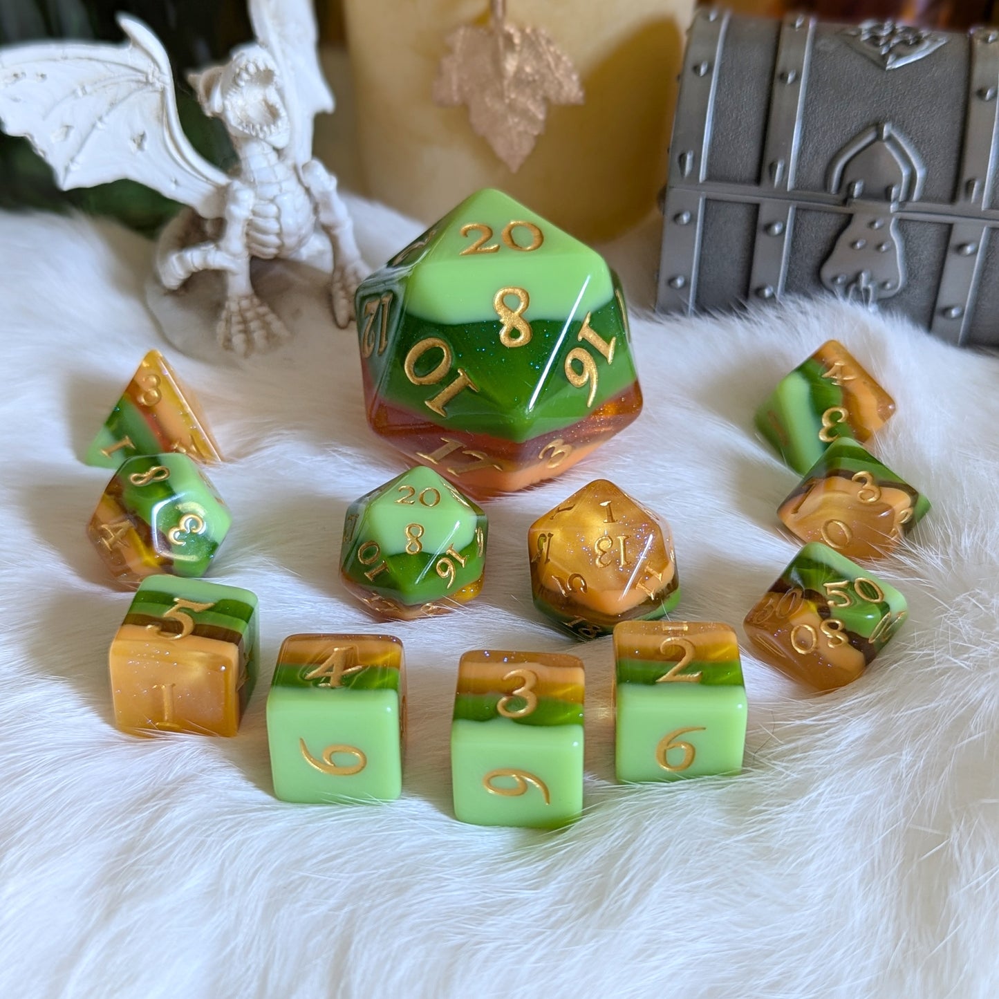 Timberlight dice set with gradient greens and browns, metallic gold numbers, displayed on white fur background with dragon and chest accents.