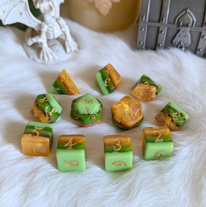 Timberlight Dice Set with nature-inspired ombre tones and gold fantasy font, featuring hues of green, brown, and yellow.