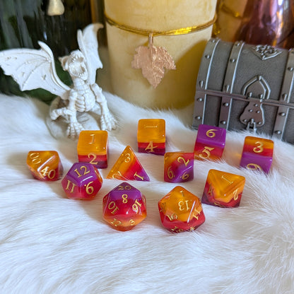 Emberstorm Dice Set on white fur with fiery orange and purple ombre resin dice, surrounded by mystical decor.