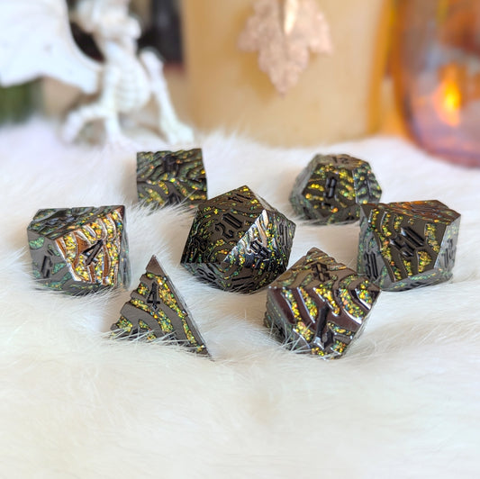 Clawstrike Metal Dice Set with silvery black finish and color-shifting green and gold glitter on a soft white background.