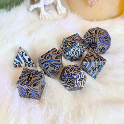 Silverfang Metal Dice Set with ocean-inspired blue glitter accents on a soft white background.