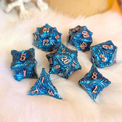 Enchanted Bark Metal Dice Set in Blue with Copper Numbers on White Surface