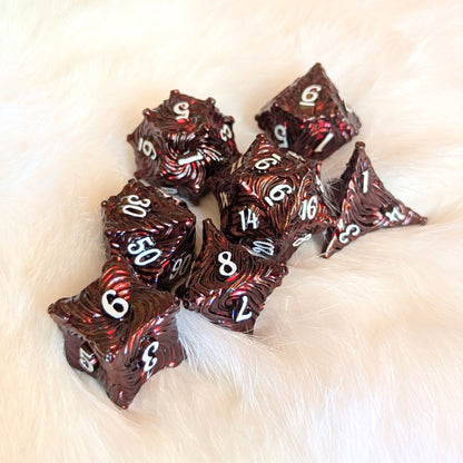 Enchanted Bark Metal Dice Set in deep red with white numbers on soft background, perfect for enhancing tabletop gaming adventures.