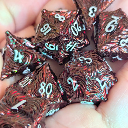 Enchanted Bark Metal Dice Set in Deep Red with White Numbers in Hand