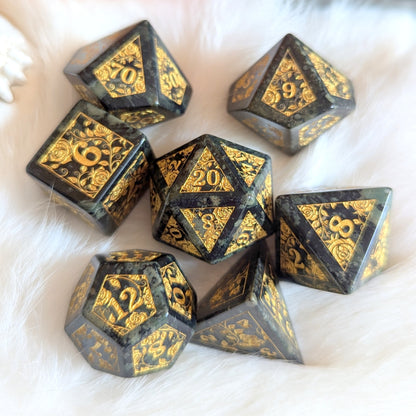 Kambaba Jasper Rose Dice Set with gold-engraved rose vines on fluffy white background.