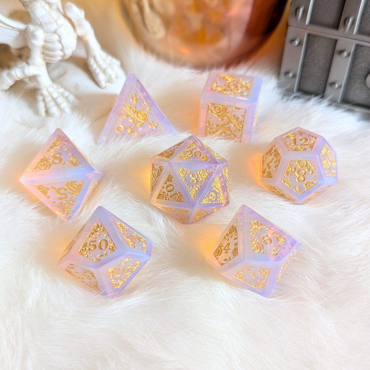 Pink Opalite Rose Vine Gemstone Dice Set with gold engravings on a soft white background, showcasing magical tabletop elegance.