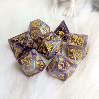 Amethyst Rose Vine Gemstone Dice Set with gold engraved rose vines on purple and white amethyst, displayed on a white background.