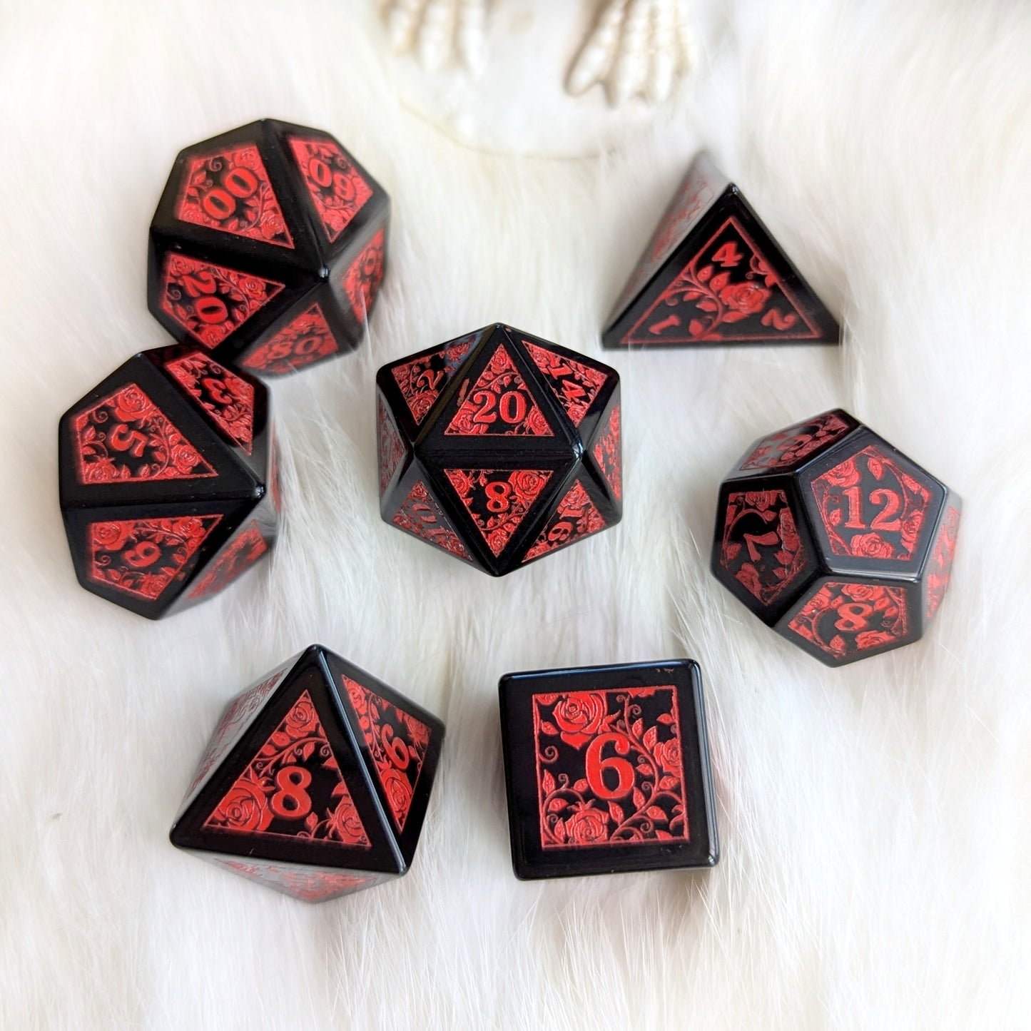 Obsidian Rose Vine Gemstone Dice Set with red rose engravings on polished black obsidian, showcasing elegance and intensity.