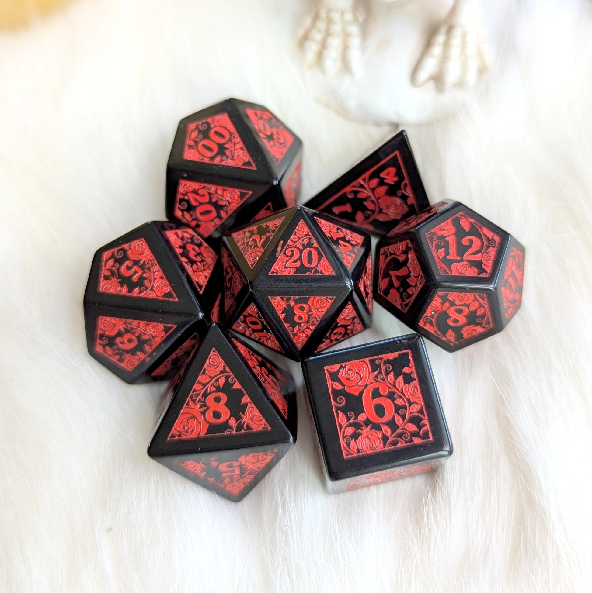 Obsidian Rose Vine Gemstone Dice Set with red rose engravings on black obsidian dice, showcasing dark elegance and fiery contrast.