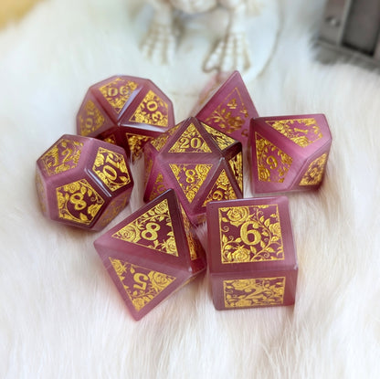 Rose Cat's Eye Rose Vine Glass Dice Set with gold engravings on fluffy surface, displaying romantic and mystical charm.