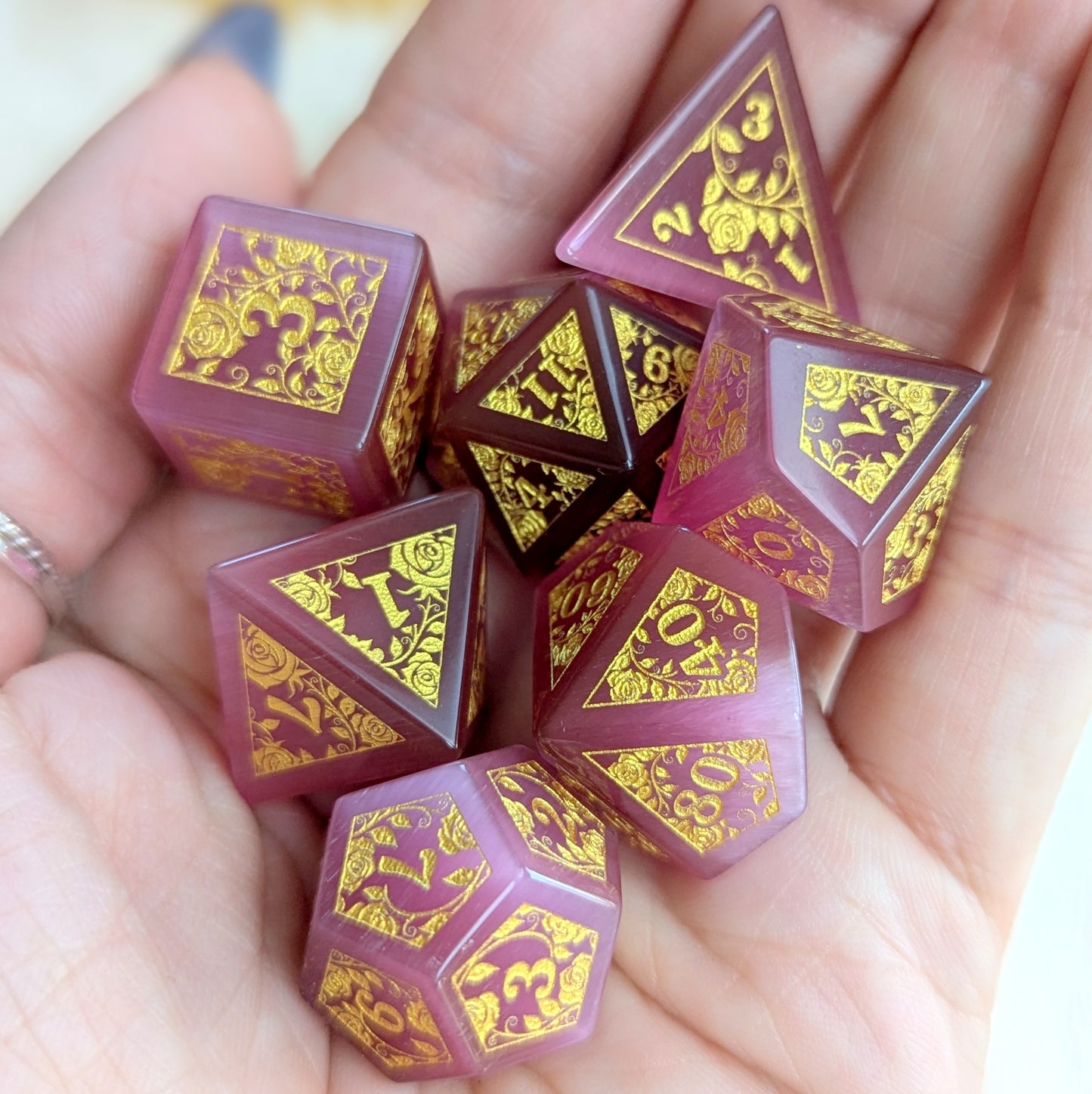 Rose Cat's Eye Glass Dice Set with Gold Rose Vine Engravings in Hand