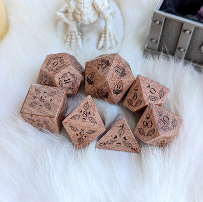 Oak Grove Engraved Rosewood Dice Set with acorn and oak leaf engravings on soft fabric background.