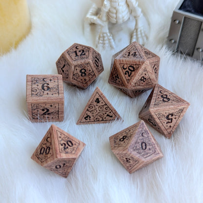 Dreamy Rosewood engraved dice set with celestial designs on fluffy white background.