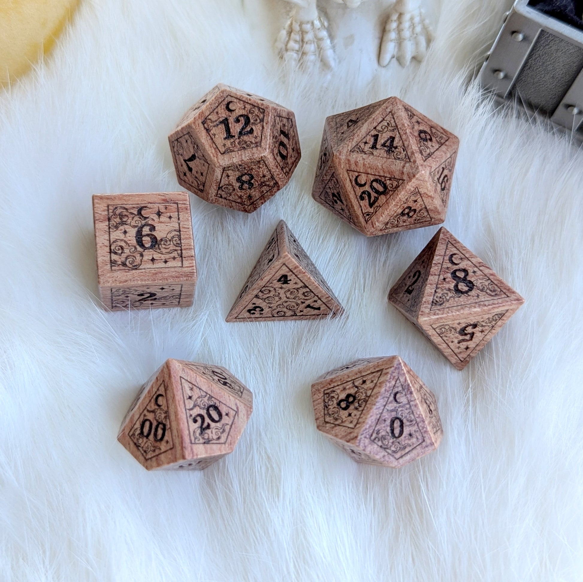 Dreamy Rosewood Engraved Dice Set with stars and moon designs, displayed on soft white fur background.