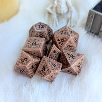 Dreamy Rosewood Engraved Dice Set showcasing intricate celestial engravings of stars and moons on a fluffy white background.