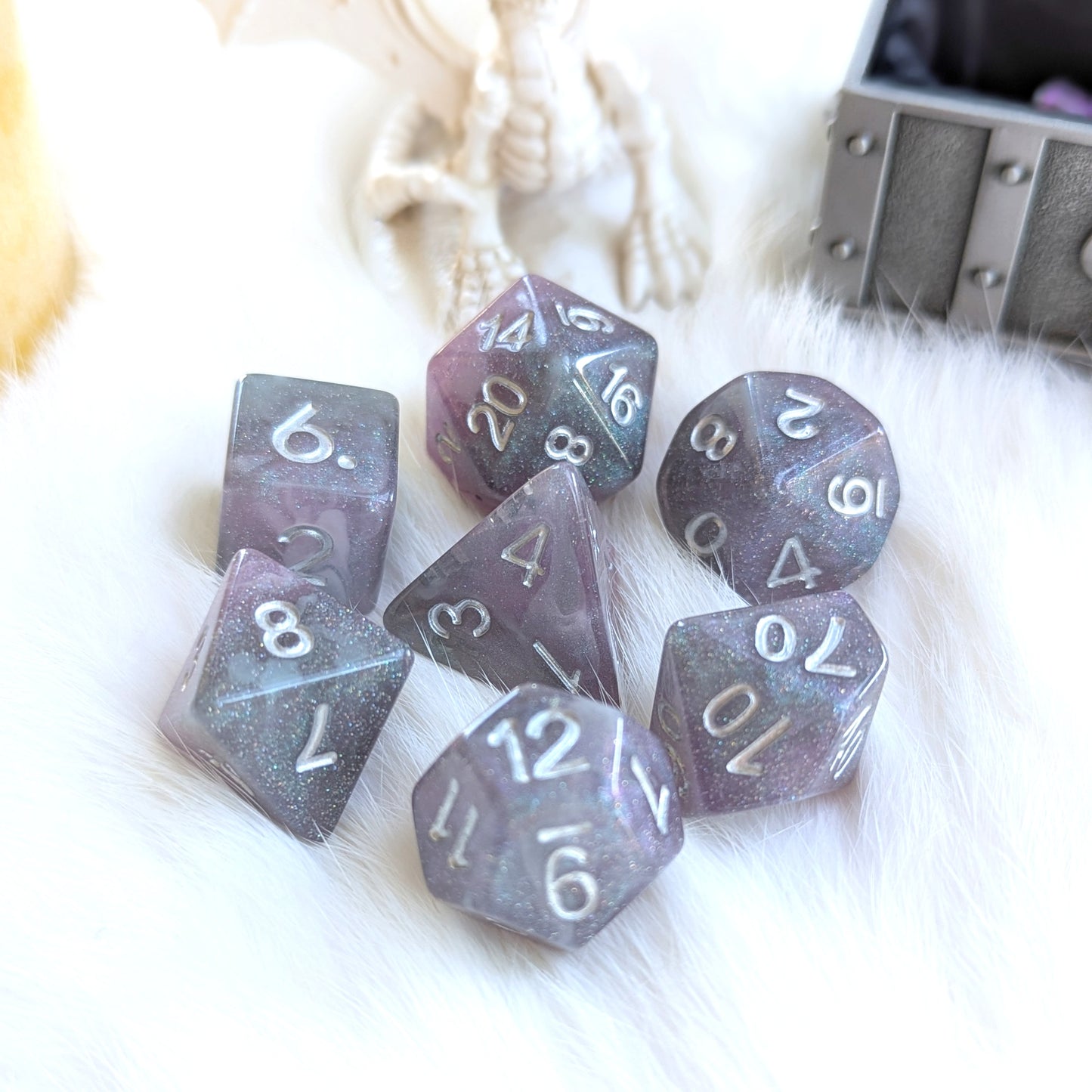 Shadow Veil Dice Set with shimmering grey, purple, and black round-edge resin dice on a white fur surface.