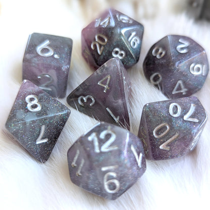 Shadow Veil round-edge resin dice set with shimmering grey, purple, and black colors, featuring elegant silver numbers.