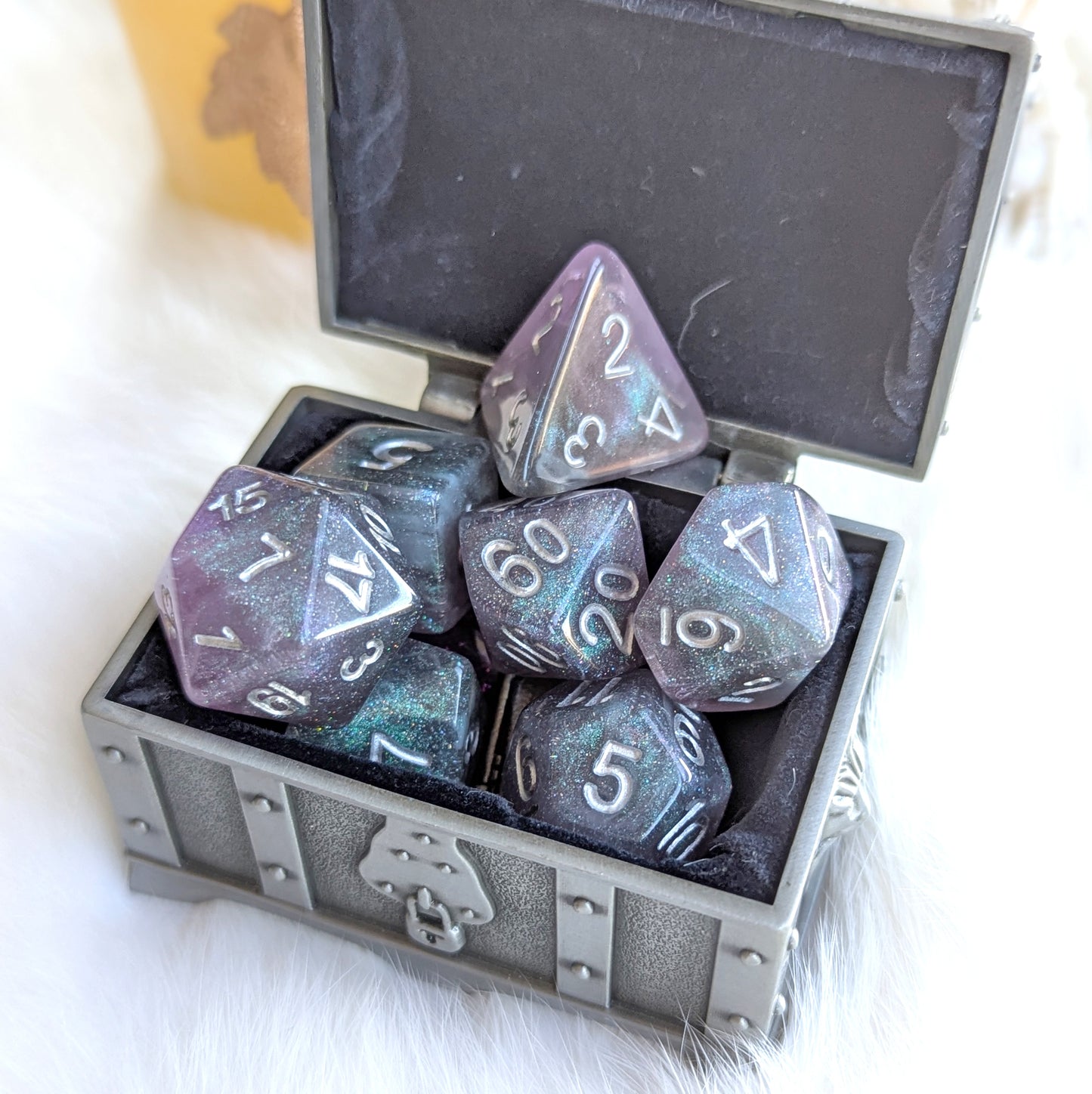 Shadow Veil Dice Set in a silver chest, featuring shimmering grey, purple, and black resin dice with silver numbers.