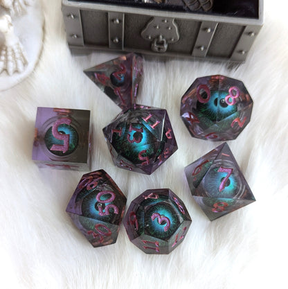 Mystic Eye Liquid Core dice set with sharp edges, featuring a vibrant blue and green eye design encased in purple resin.